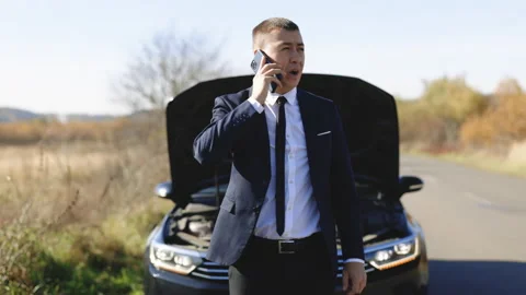 Man calling car assistance services. Unhappy businessman speak on phone near the 스톡 동영상 194753534