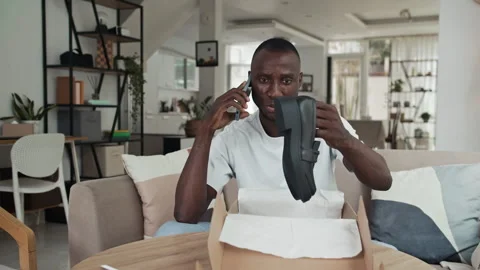Man Calling to Customer Service when Getting Wrong Shoes in Parcel Video stock 281711959