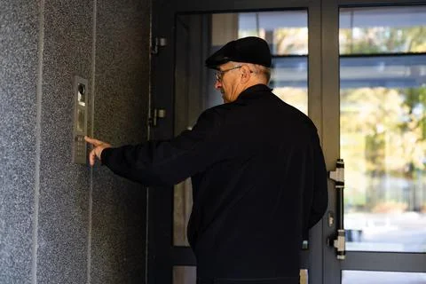 Man calling by the intercom, from an apartment building Fotos de archivo