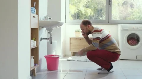 Man calling a professional plumber Stock Footage 297856021