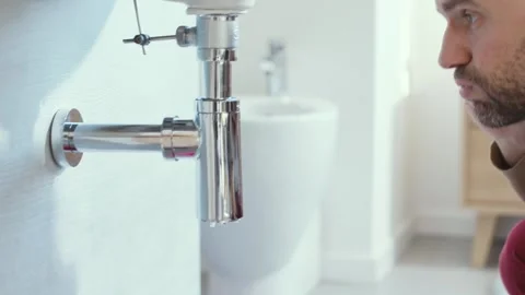 Man calling a professional plumber Stock Footage 297856099