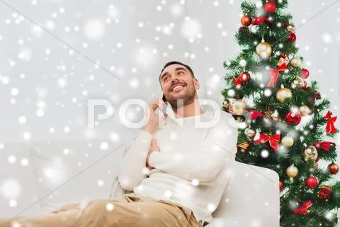 Man calling on smartphone at home for christmas Stock Photos