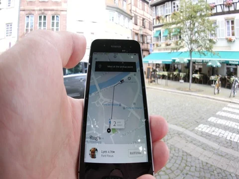 Man calling uber taxi driver in French city Stock Footage 77559896