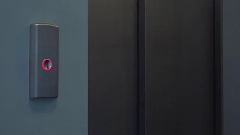 A man calls an elevator by pressing a button - closeup Stock Footage 82233836