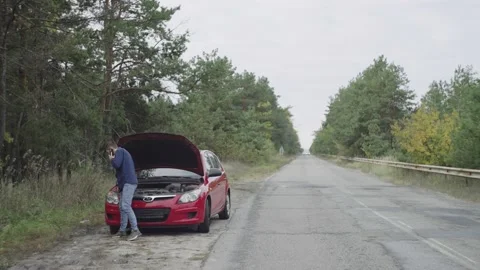 A man calls for help on the phone, the car breaks down, malfunction Stock Footage 236777525