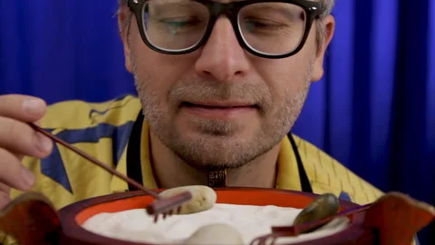 Man calms down using japanese mini rock garden. Stock Footage 134858849