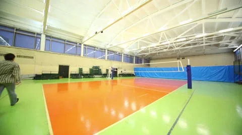 Man came and turn off light inside school gym hall Stock Footage