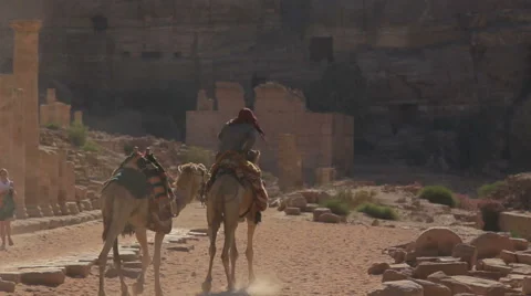 Man on a camel walking away in the lost city of Petra Stock Footage 62189888
