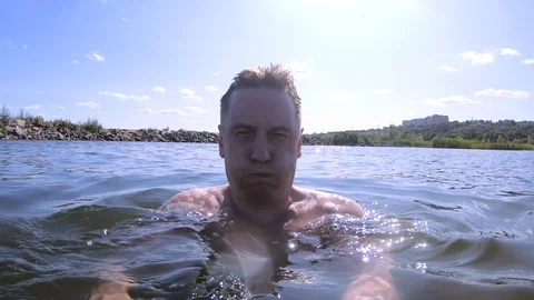 A man with a camera dives under the water Stock Footage 114561700