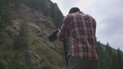 Man with camera long lens Stock Footage 54707077