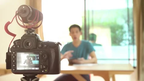 A man with a camera recording him for influencer concept Stock Footage 314899861