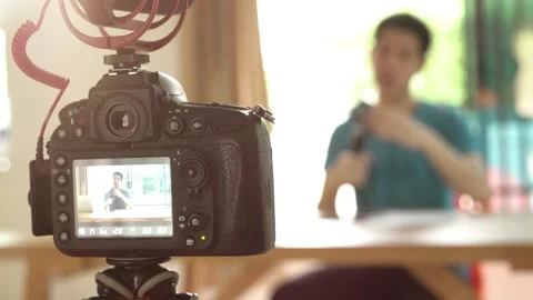 A man with a camera recording him for influencer concept Stock Footage 314899902