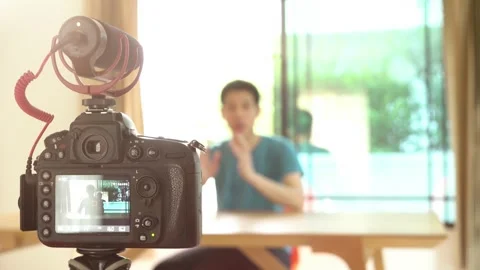 A man with a camera recording him for influencer concept Stock Footage 315116680