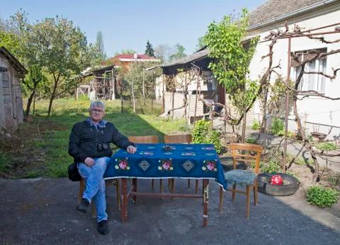 Man with a camera at a table in the yard Stock Photos