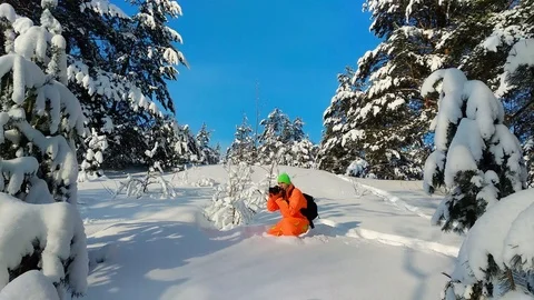 Man with camera taking photo outdoors in winter snowy landscape. Stock Footage 86846992