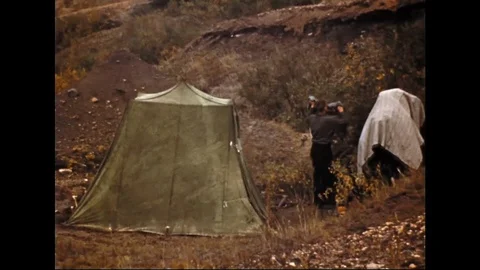 Man With Camping Tent Hanging Up Clothes On Bushes Stock Footage 104886820