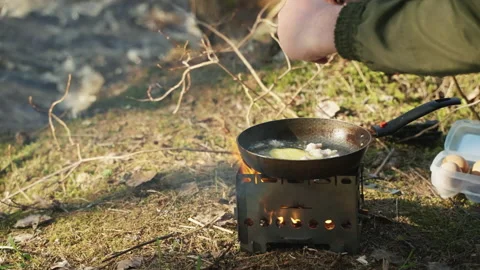 https://images.pond5.com/man-camping-trip-cooks-scrambled-footage-195241036_iconl.jpeg