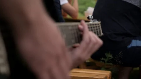 A man in a camping trip playing guitar Stock Footage 112620989