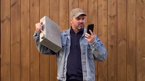 Man with canister screaming while talking on phone 4K Stock Footage 291264247