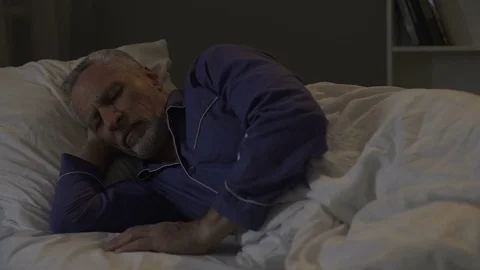 Man cannot fall sleep, exhausted by bad thoughts and sad memories, insomnia Stock Footage 78645042