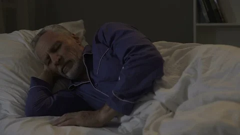 Man cannot fall sleep, exhausted by bad thoughts and sad memories, insomnia Stock Footage 78656883