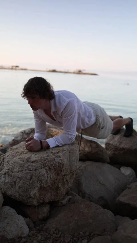 Man cannot relax on vacation and turns seaside leisure into another workout Stock Footage 341621813