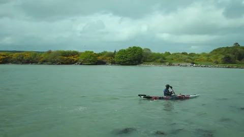 A man canoeing on a cloudy day Stock Footage 236708324