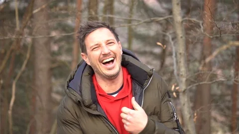 A man can't stop laughing into the camera in slowmotion Stock Footage 103863894