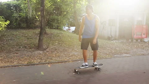 A man in a cap and glasses is riding a skateboard. Stock Footage 94861715