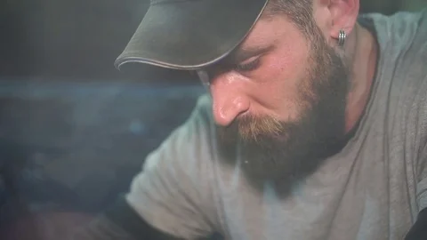 Man in a cap with a beard busy on work 스톡 동영상 80320452