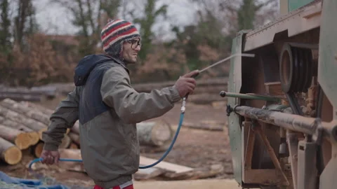 Man in a cap cleaning a machine with air Stock Footage 271168890
