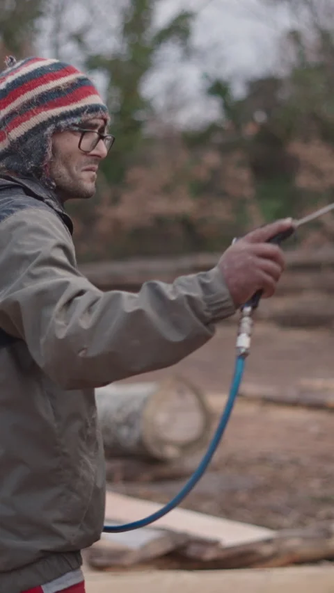 Man in a cap cleaning a machine with air Stock Footage 273183050
