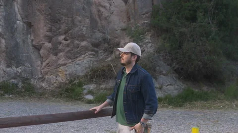 Man in cap gazes into distance by the river Stock Footage 265105810