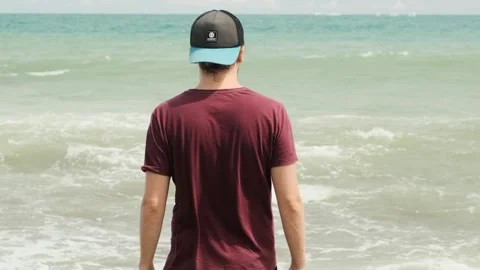 Man with a cap looking at the horizon Stock Footage 138793114