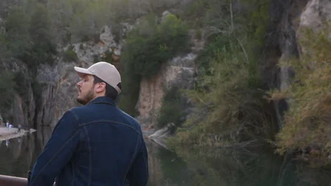Man in cap looking thoughtfully into the distance Stock Footage 265105951