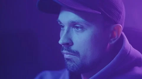 A man in a cap looks at a close-up of a computer screen Stock Footage 211800792