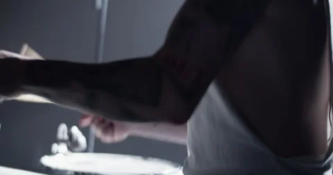 Man in cap playing beat on drum set on stage Stock Footage 249853360