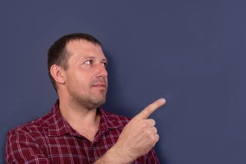 Man in a cap points to the side, banner Stock Photos
