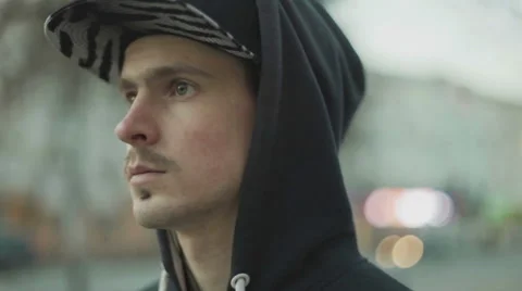 Man in a cap pulls earphone close-up Stock Footage 59827792