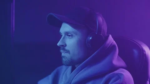 Man in a cap tensely plays computer games Stock Footage 216937577
