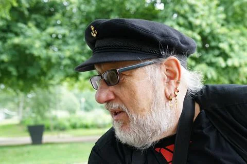 Man with captains hat talks Stock Photos