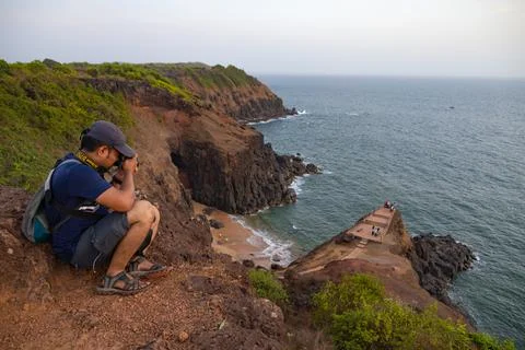 Man capturing beautiful landscape of Devghali Beach, Kasheli Stock Photos