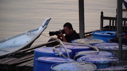 Man capturing sunset scene with his camera Stock Footage 104762583