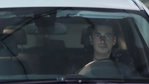 Man is in car behind front window with reflection during move backward Stock Footage 276366349