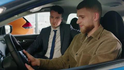 A man in a car during a test drive and the manager is sitting next to him Stock Footage 203769718