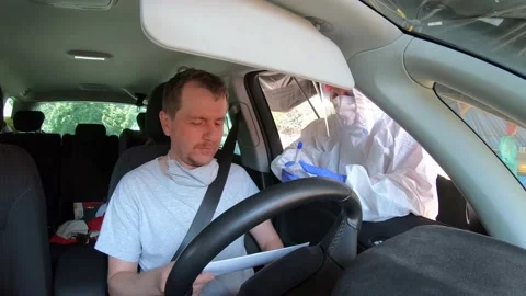 Man in car having PCR test for possible covid-19 infection Stock Footage 136893452