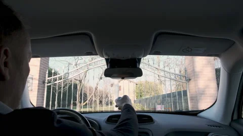 Man from car interior, operates with his thumb the remote control Stock Footage 168146747
