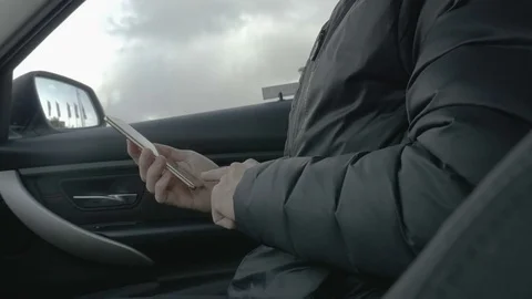 Man in a car login on a smart phone with fingerprint reader Stock Footage 81371153