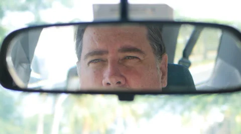 Man in car looking to left border rear view mirror  3 Stock Footage 32273019