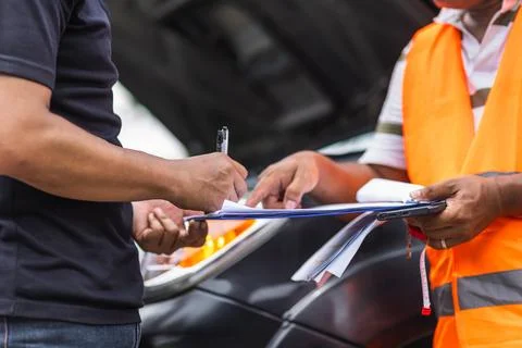 Man car problem crash breakdown signing claim contract insurance document w.. Stock Photos